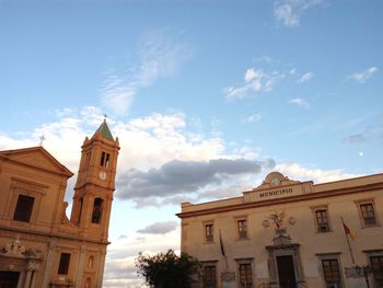 Low angle view of clock tower against sky