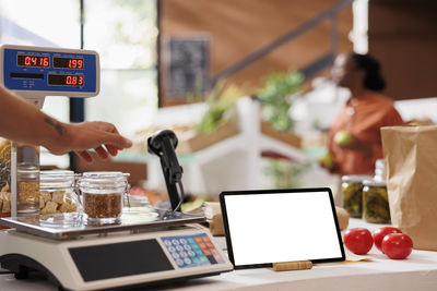 Midsection of woman using laptop on table