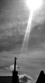 Low angle view of silhouette building against sky