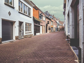 Footpath amidst houses in city