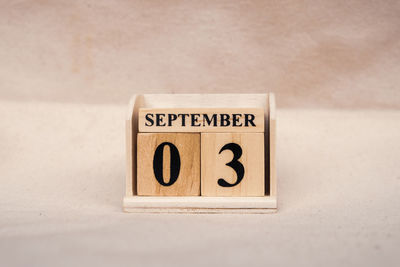 Close-up of information sign on table