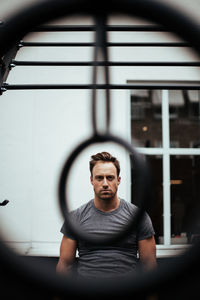 Portrait of confident man exercising in gym