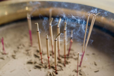 High angle view of incense in container