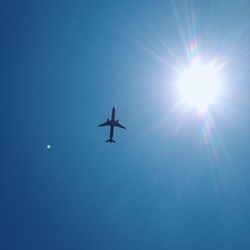 Low angle view of airplane flying in sky