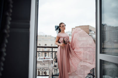 Woman standing by window