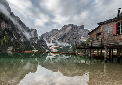 Lake by buildings against sky