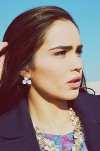 Close-up portrait of young woman looking away