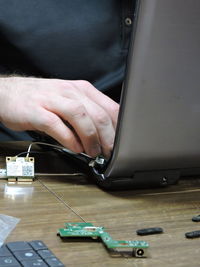 Engineer repairing equipment at desk