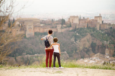 Rear view of women standing on looking at view