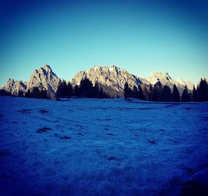 Scenic view of mountains against clear blue sky