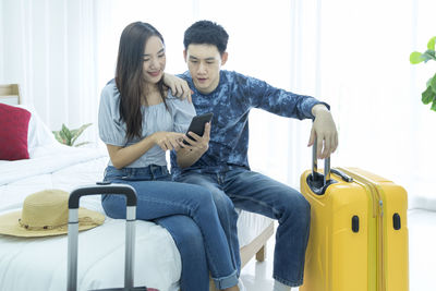 Young couple holding smart phone