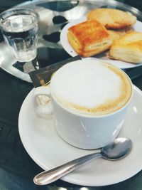 Close-up of cappuccino served on table