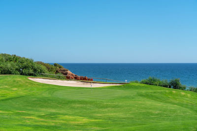 Scenic view of sea against clear blue sky