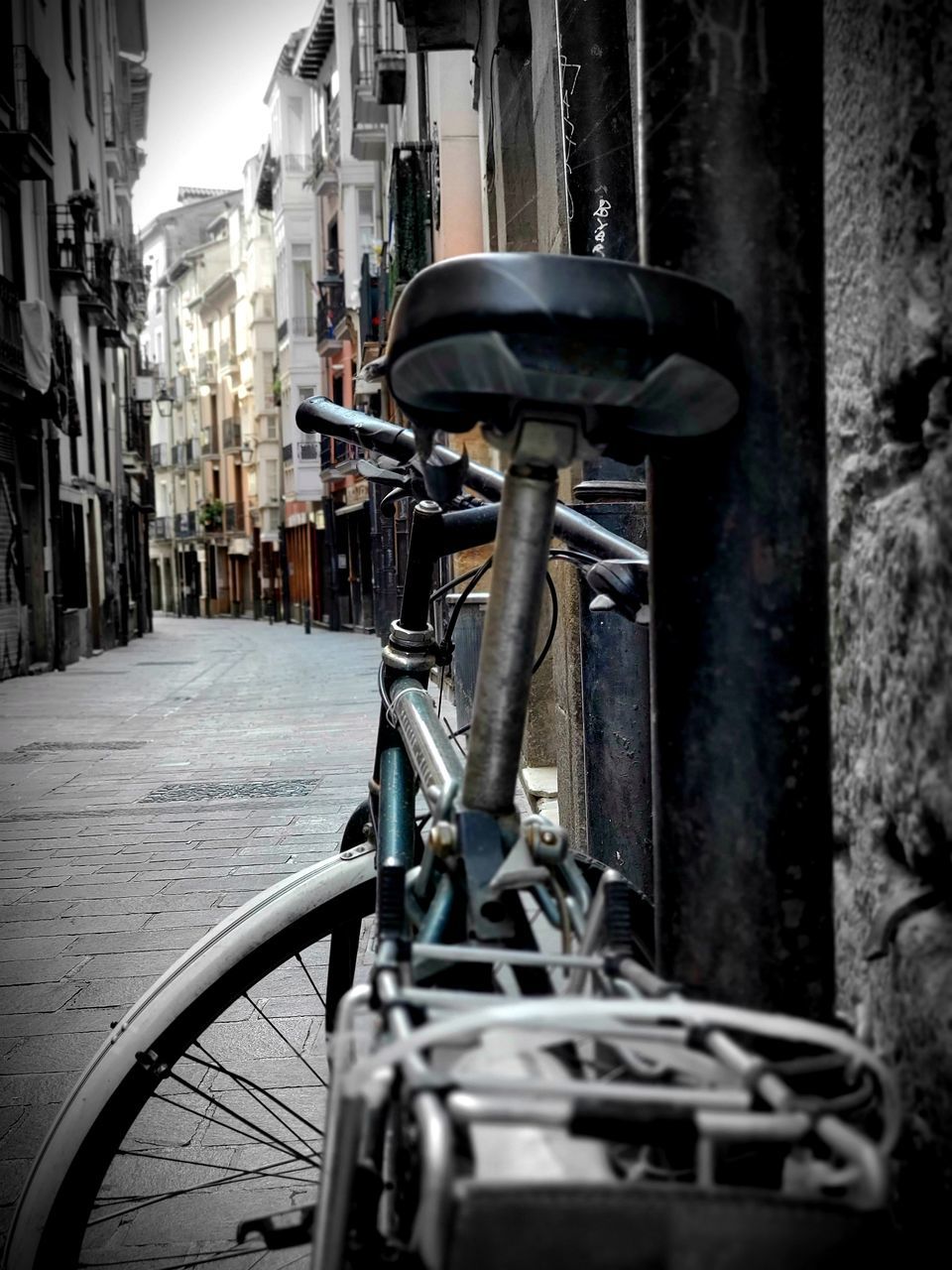 BICYCLE PARKED ON STREET IN CITY