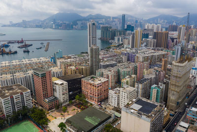 High angle view of buildings by sea against sky