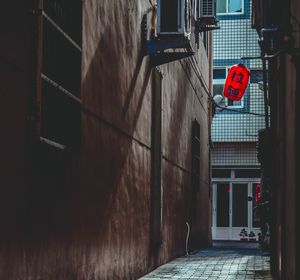 Empty alley amidst buildings in city