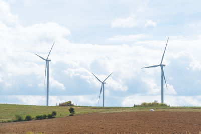 Windmill on field against sky