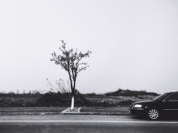 Cars on road against clear sky