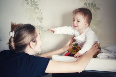 Cute mother with baby at home