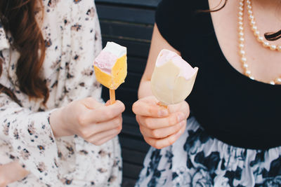 Midsection of woman holding ice cream