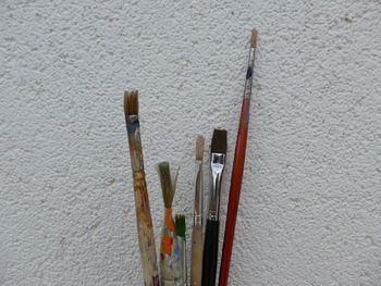High angle view of paintbrushes on wall