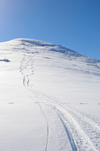 Scenic view of snow covered mountain against sky