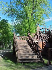 Footbridge over footpath against sky