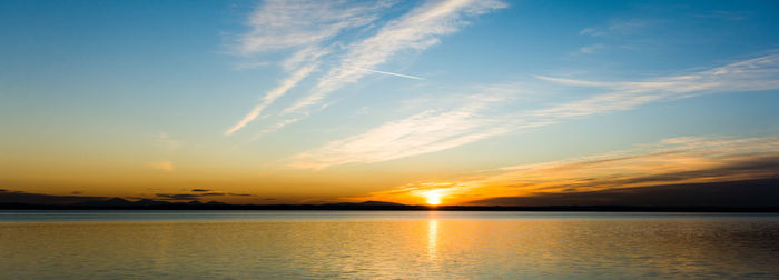 Scenic view of lake against sky during sunset