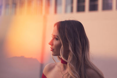 Portrait of young woman looking away outdoors