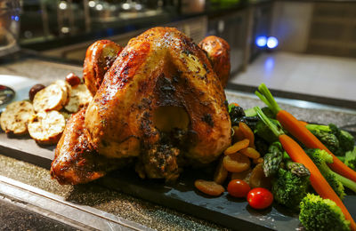 Close-up of roasted chicken on slate