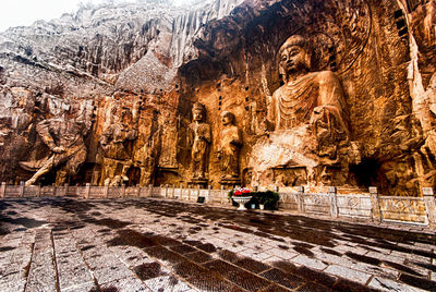 View of tourists on rock in cave