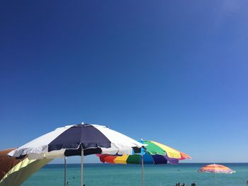 Tent on beach against clear blue sky