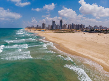 Scenic view of sea and buildings against sky