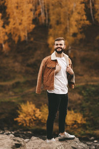 Portrait of young man standing on land