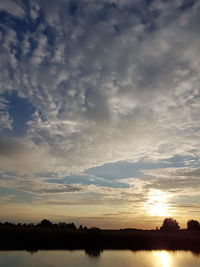 Scenic view of silhouette landscape against sky at sunset