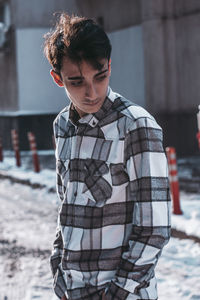 Portrait of young man standing outdoors