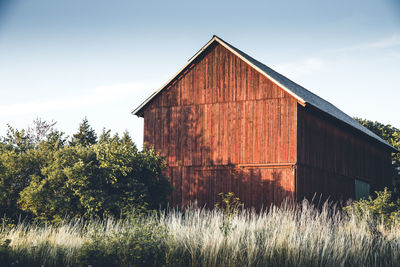 Barn on field against sky