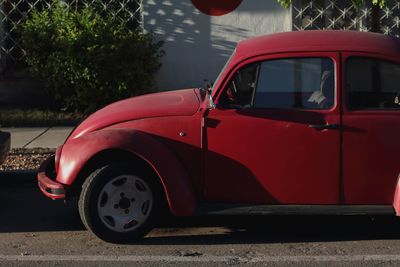 Red vintage car on street in city