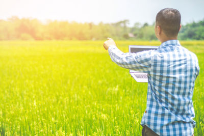 Rear view of man standing on field