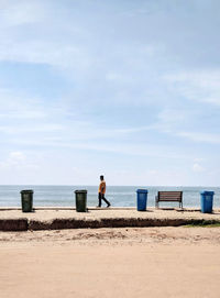 Man on beach against sky