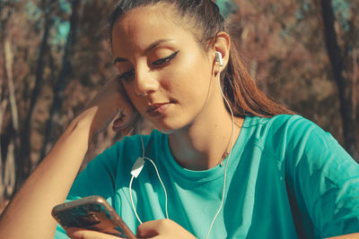 Portrait of young woman using mobile phone