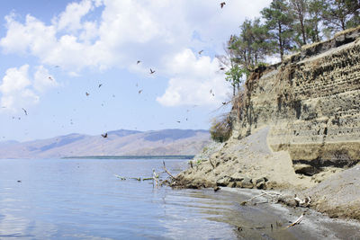 Scenic view of sea against cloudy sky