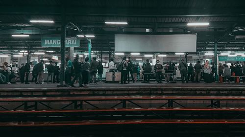 People waiting at railroad station platform