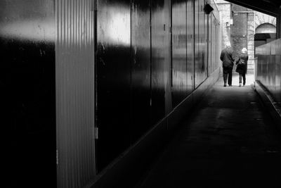 Full length of woman walking on sidewalk