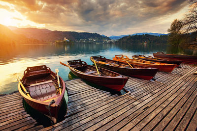 Panoramic view of boats moored in lake against sky during sunset