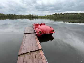 Scenic view of car in lake against sky