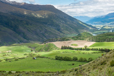 Scenic view of landscape and mountains against sky