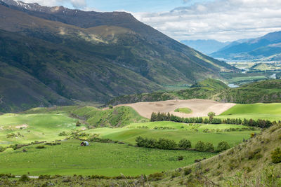 Scenic view of landscape and mountains against sky