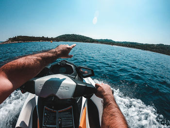 Midsection of man on sea against sky