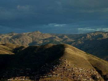 Scenic view of mountains against cloudy sky